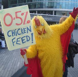 bloke in chicken suit with placard